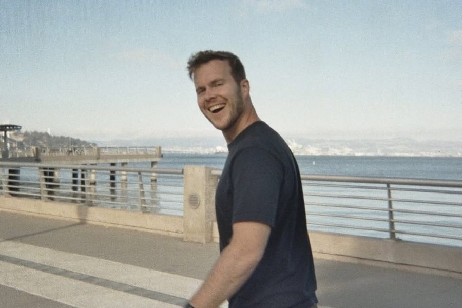 Marc Tuinier laughing on a pier by the bay